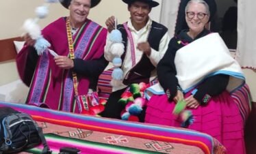 Cozy room with two single beds and one double, private bathroom, hot shower, and Lake Titicaca view in Puno, Peru