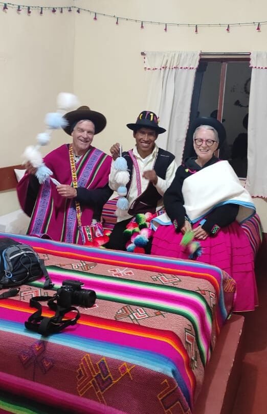 Cozy room with two single beds and one double, private bathroom, hot shower, and Lake Titicaca view in Puno, Peru