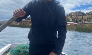 Travelers fishing with local residents on Lake Titicaca experiencing authentic community life in Puno, Peru