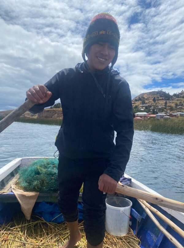 Travelers fishing with local residents on Lake Titicaca experiencing authentic community life in Puno, Peru