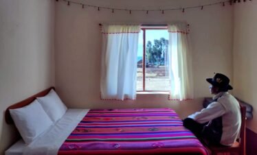 Cozy guestroom with comfortable beds and traditional hospitality in Luquina Chico by Lake Titicaca Puno Peru