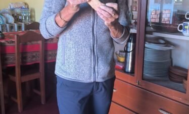 Visitor making Tojjto traditional bread in Luquina Chico kitchen by Lake Titicaca, Puno, Peru
