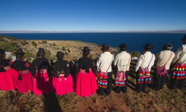 Community members gazing at Lake Titicaca and surrounding hills in Luquina Chico, Puno, Peru